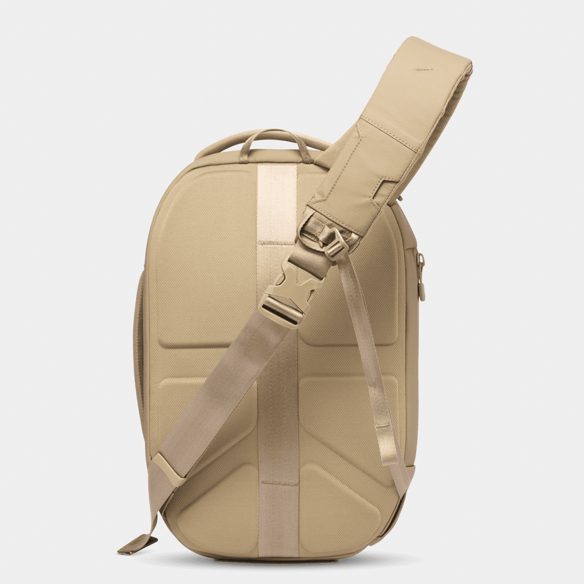 Side view of the Nomatic Navigator RS Sling 10L in beige, showcasing its sleek design and adjustable shoulder strap.