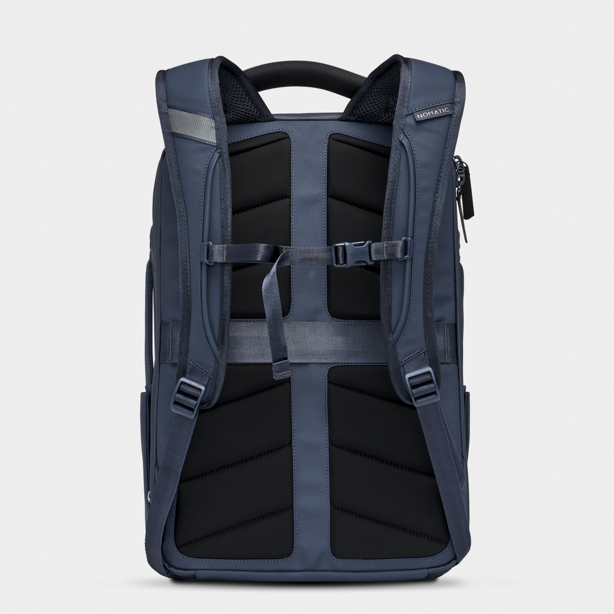 Rear view of the Nomatic Travel Pack in navy blue, showing padded shoulder straps, back panel, and sternum strap for ergonomic support.